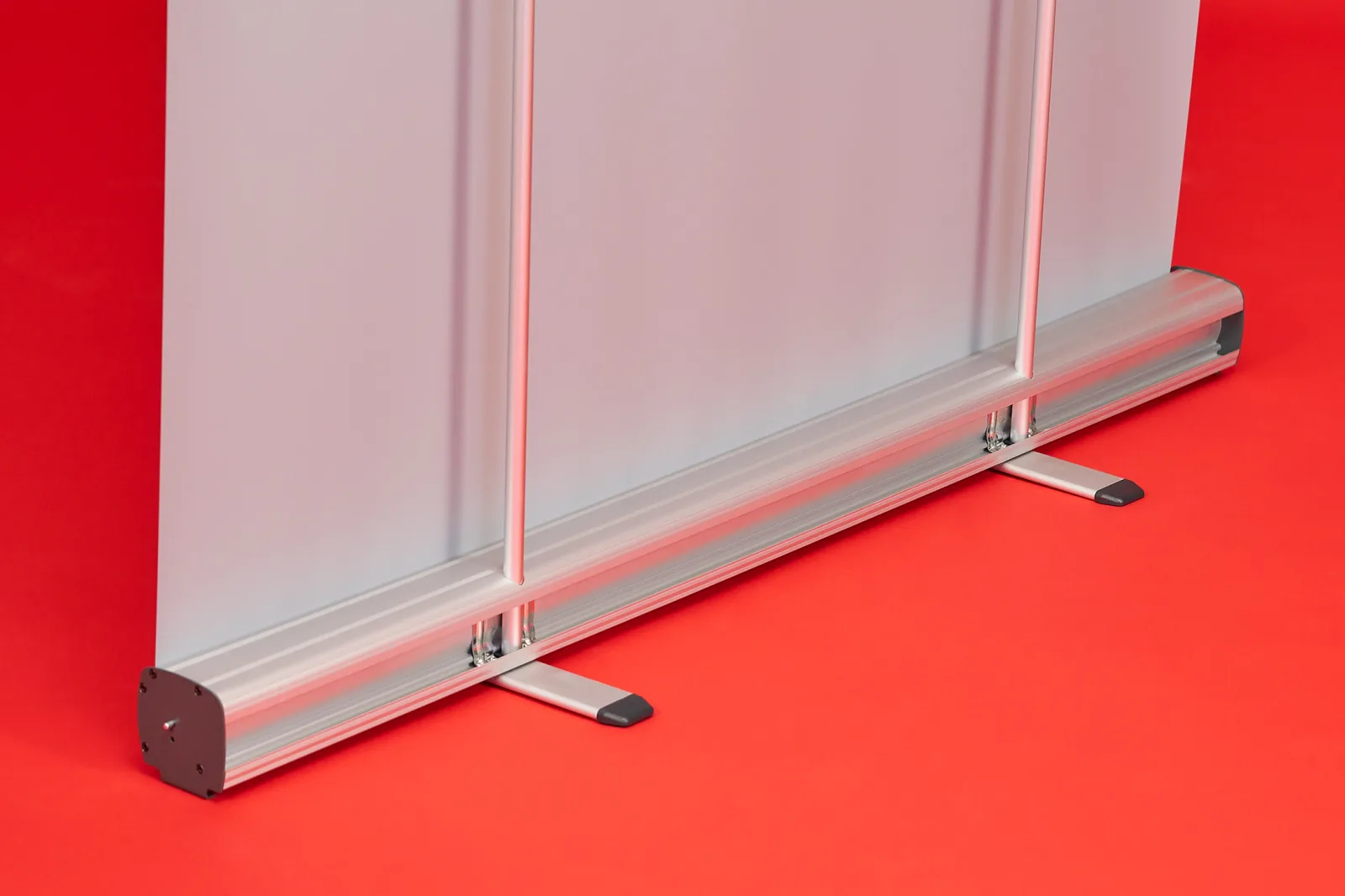 rear of the reverse of a silver classic roller banner cassette with 2 support feet and 2 support poles on a bright red background