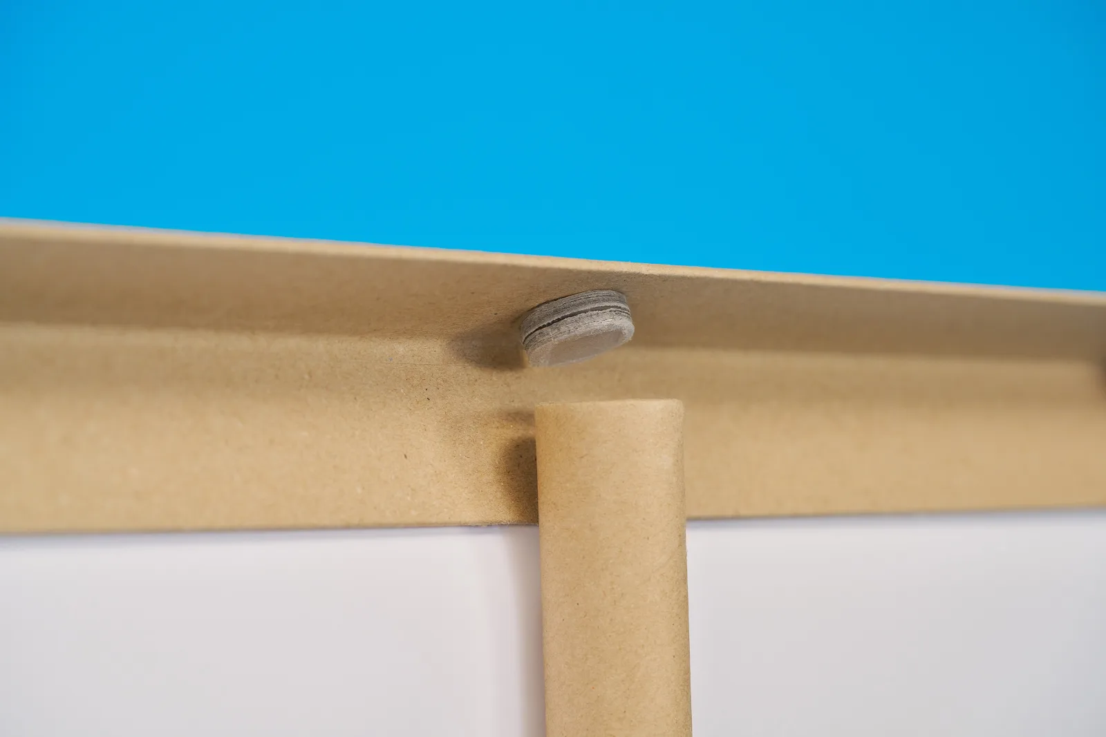 close up of the top support and pole of a eco friendly roller banner on a bright blue background