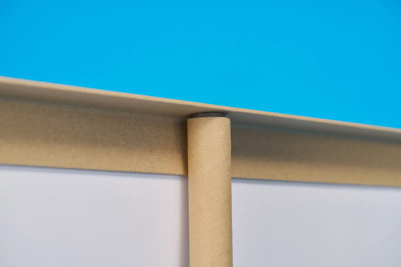 close up of the top support and pole of a eco friendly roller banner on a bright blue background