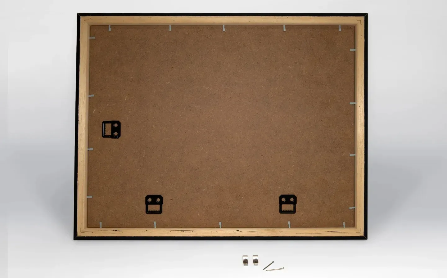 Back view of a framed print displaying wood, screws, and the mount