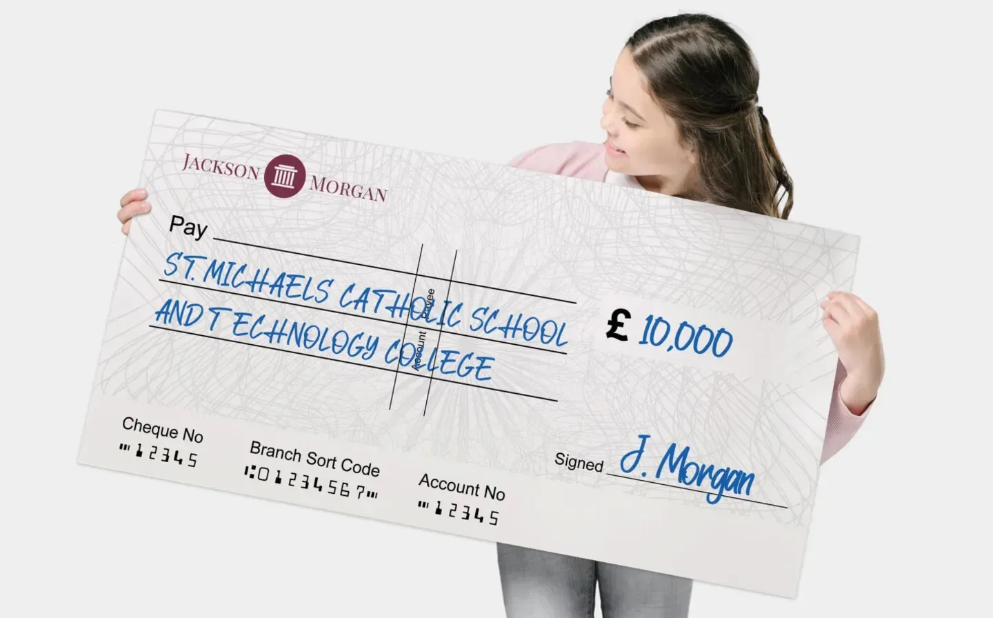 A young woman proudly holds a large charity check, symbolising a generous donation
