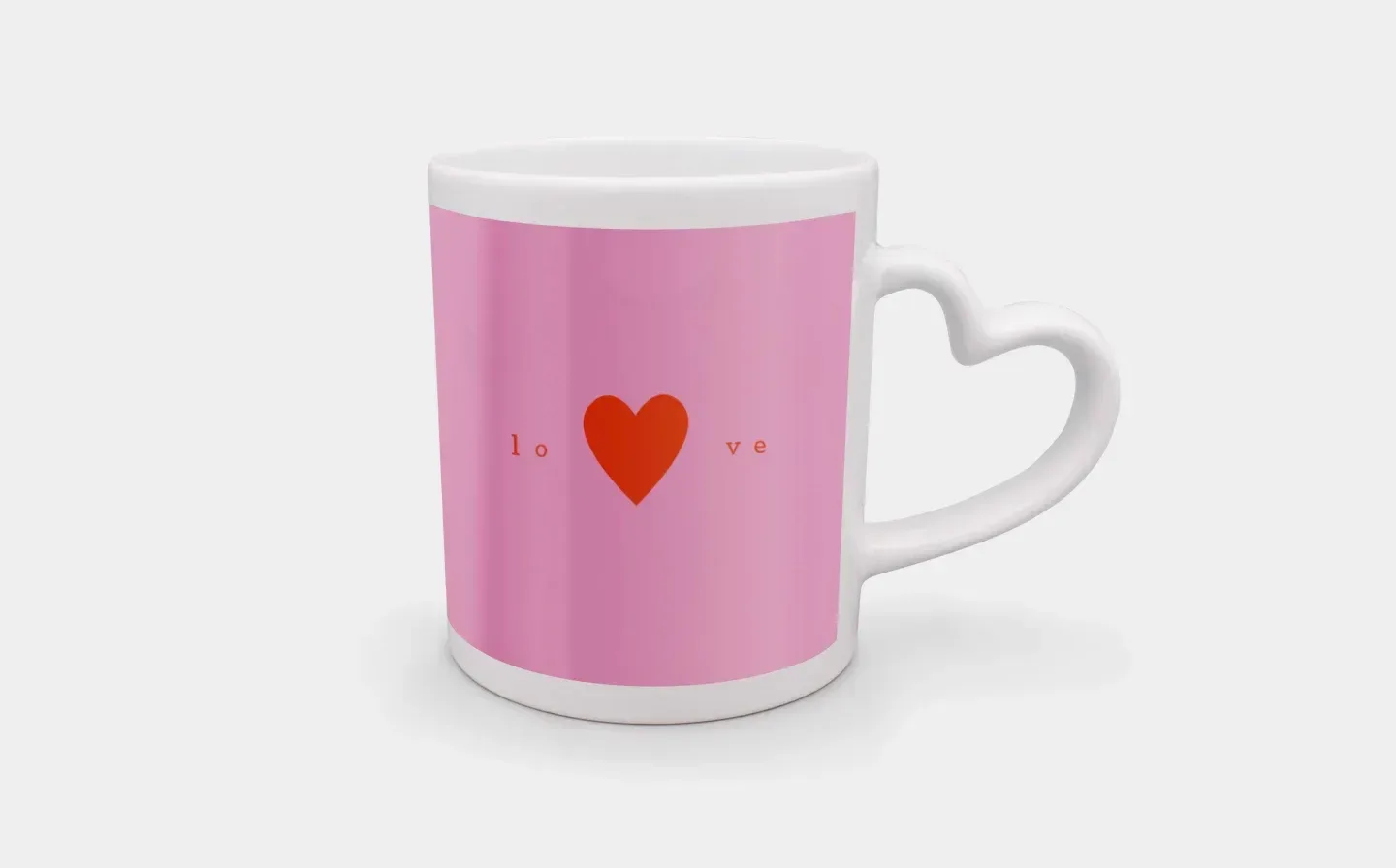 A heart handle mug adorned with a pink and red heart design, featuring the word "Love"