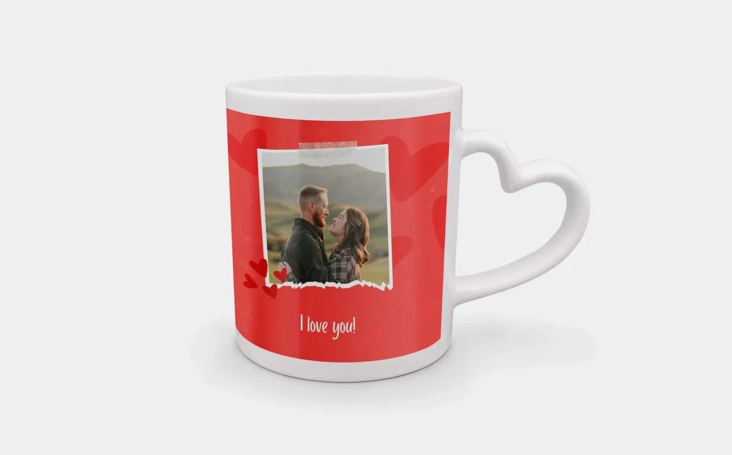 A heart handle mug featuring a photograph of a couple, and the phrase "I love you!" on a plain background