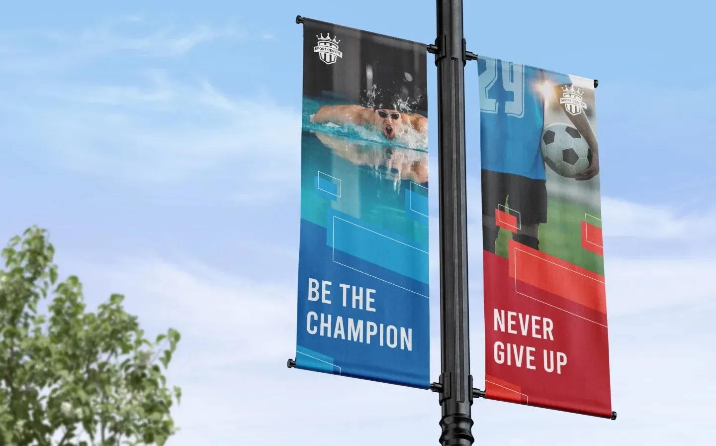 Athletic-themed lamp post banners set against a bright blue sky, enhancing the urban landscape