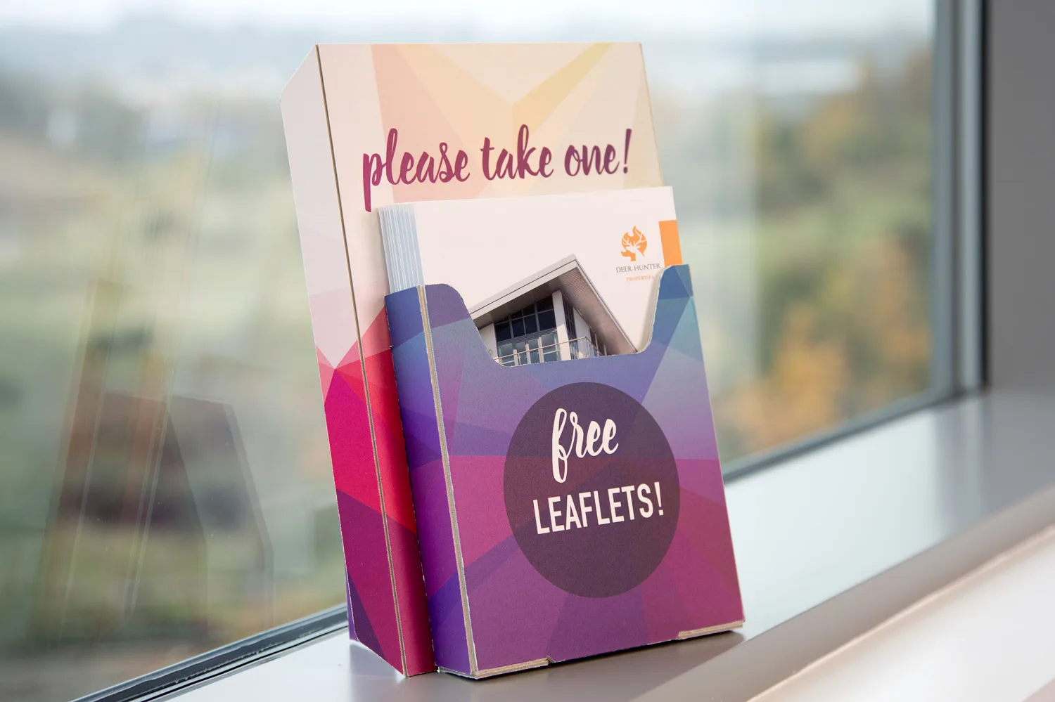 A leaflet holder displaying free leaflets for the 'Winslough City Health Day Fair', displayed on a windowsill