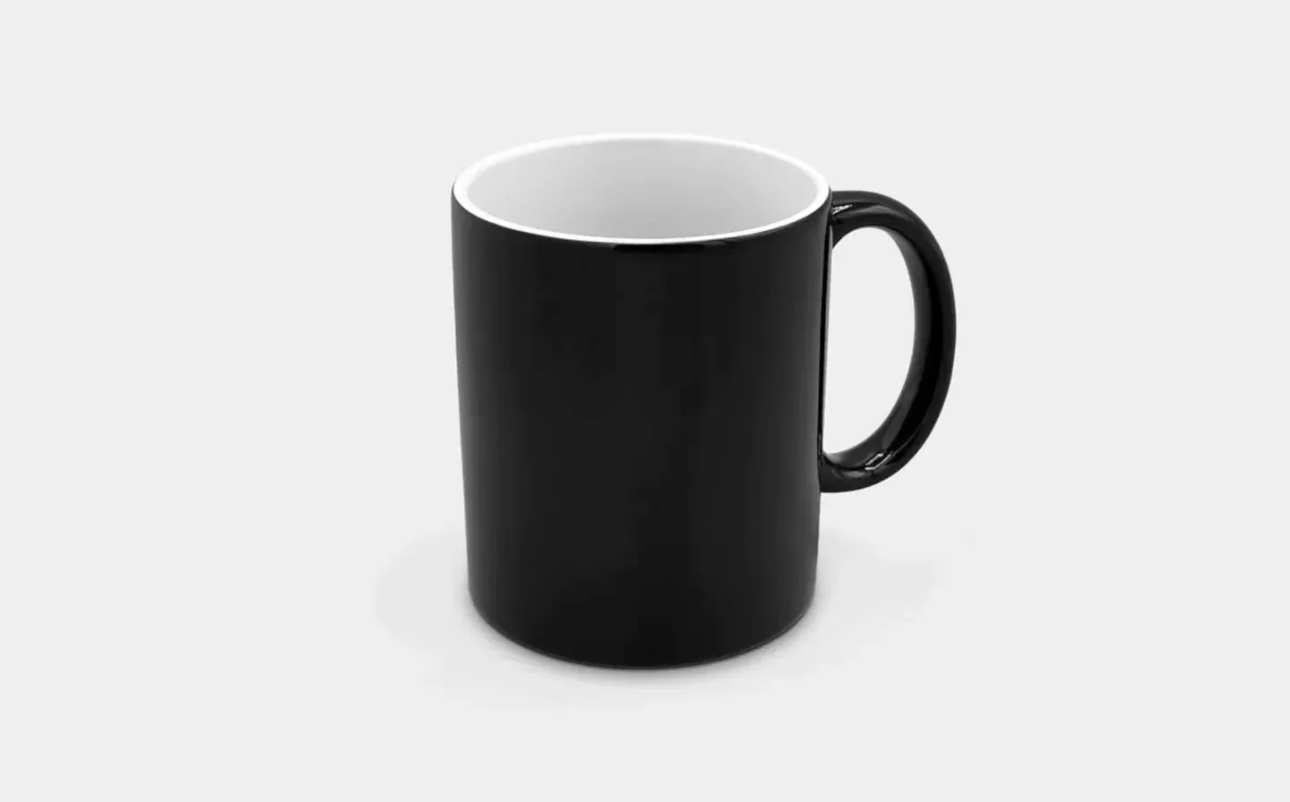 A magic mug on a white surface, awaiting hot water to activate its heat-changing feature