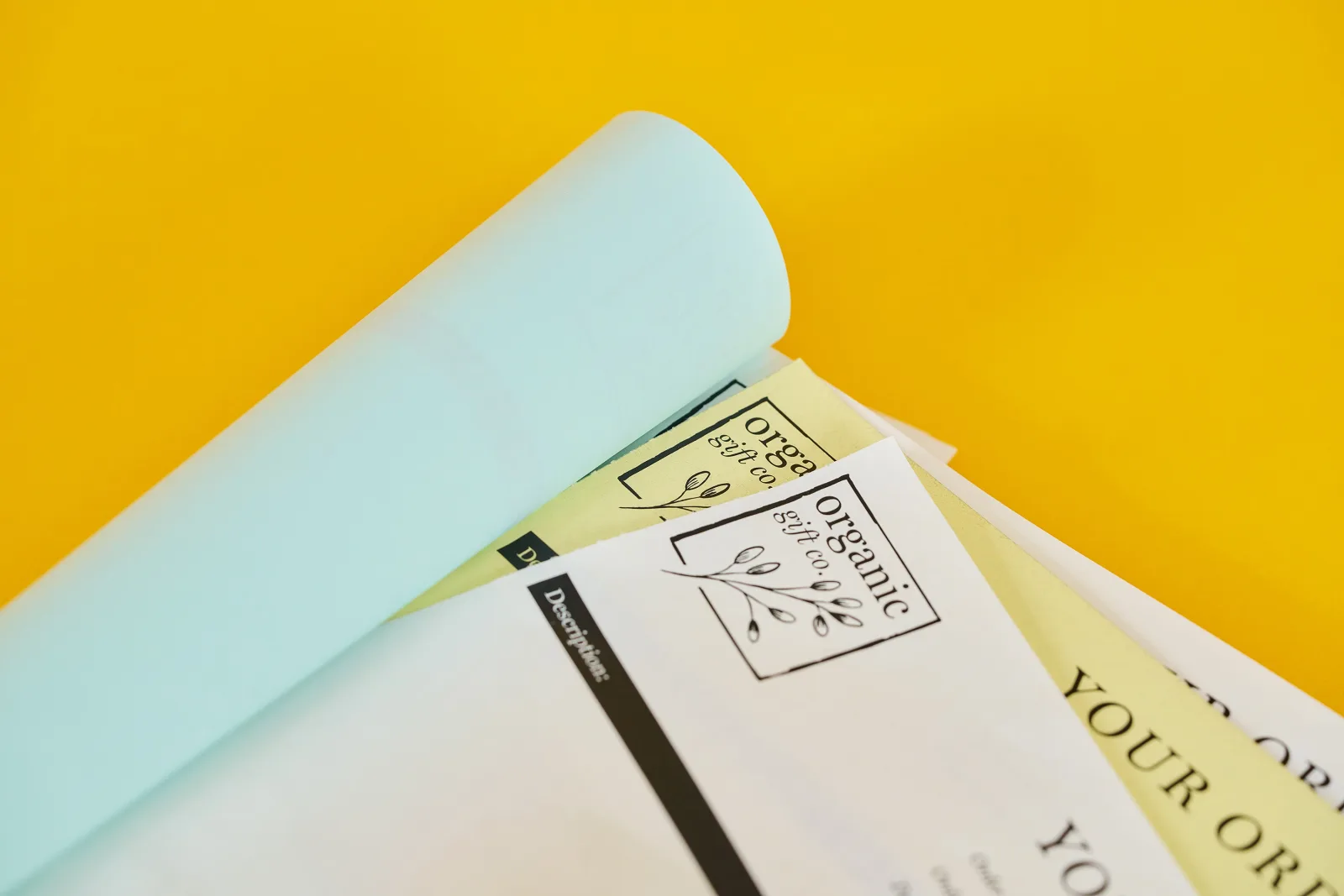 ncr book showing page perforation with blue and yellow duplication sheets on a bright yellow background