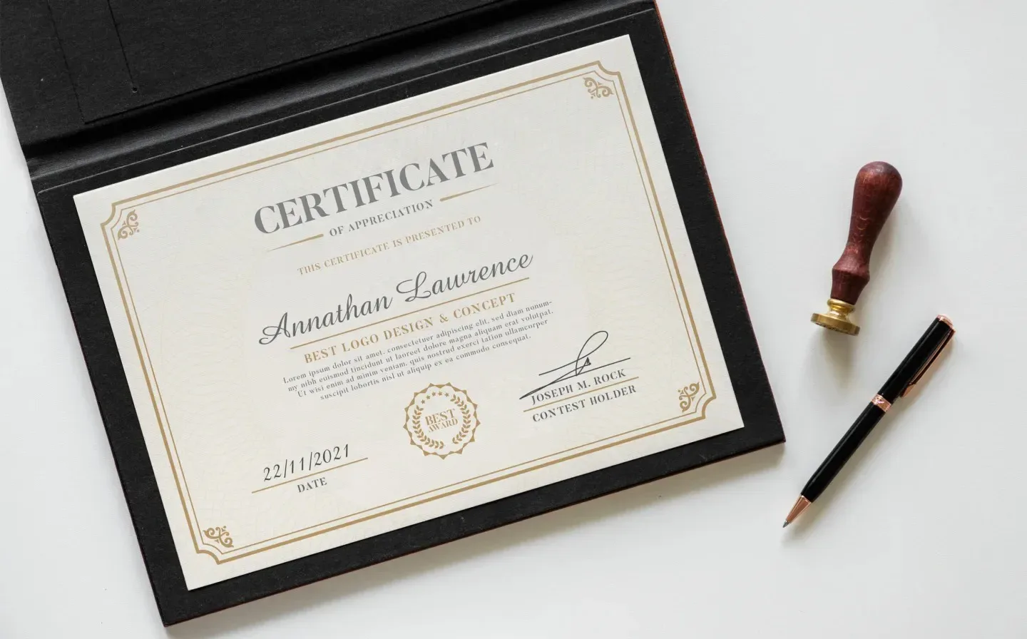 A certificate alongside a pen and stamp, set against a pristine white background, showcasing its elegant layout