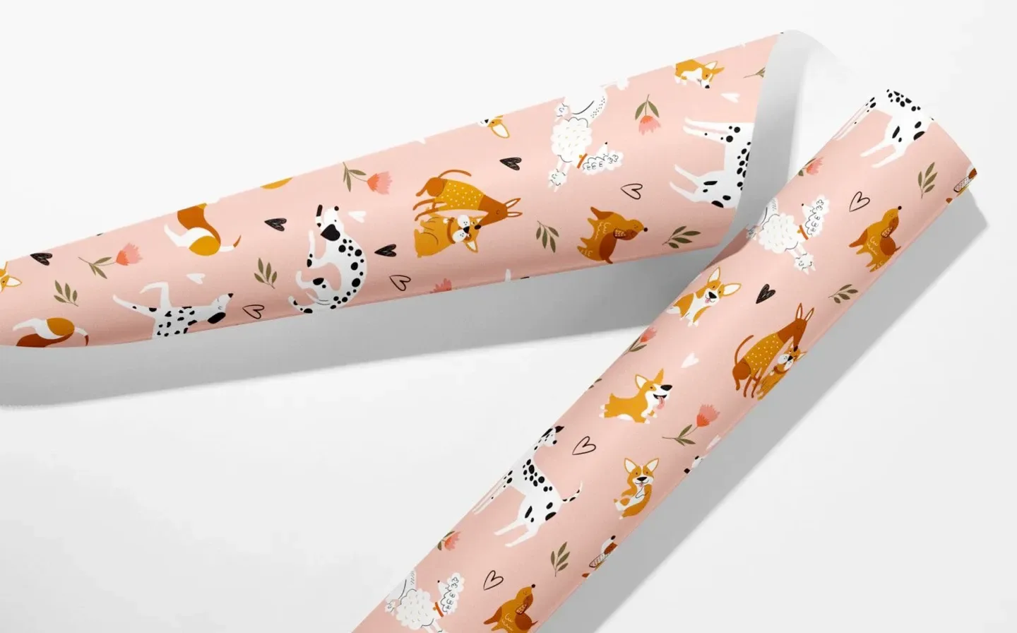 Two wrapping paper rolls featuring playful dog designs on a plain background