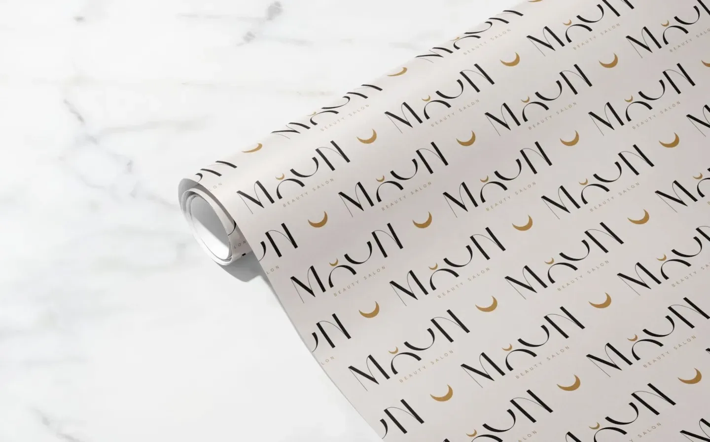 A wrapping paper roll featuring the word "Moon" and moon decals in a decorative design