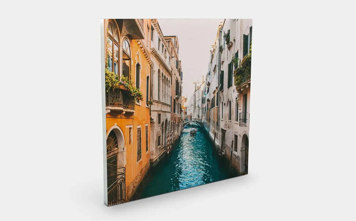 A close-up photo tile of a serene canal in Venice, Italy