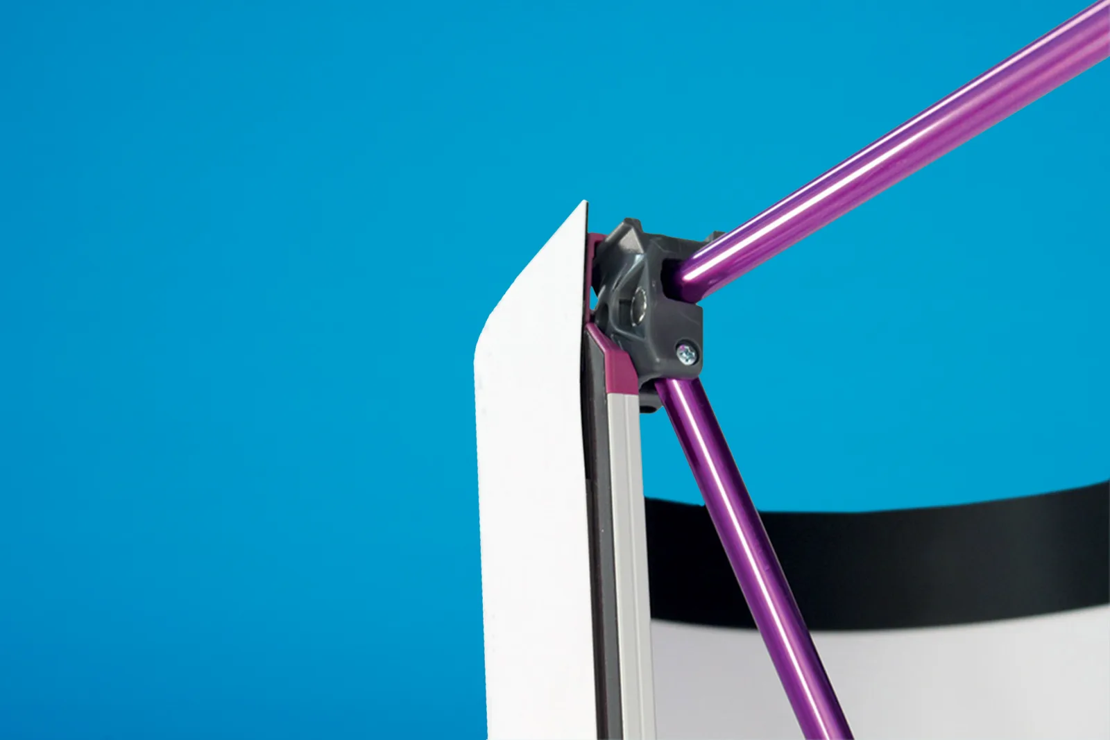 close up of the corner a pop up stand frame showing magnetic rods and purple metal frame on a bright blue background