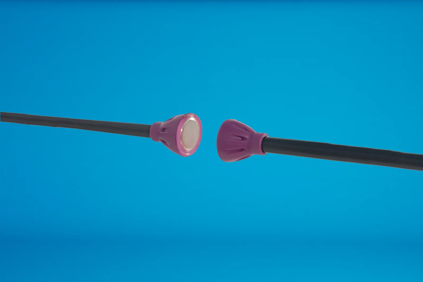 purple magnetic connectors showing magnet and black pole construction on a bright blue background