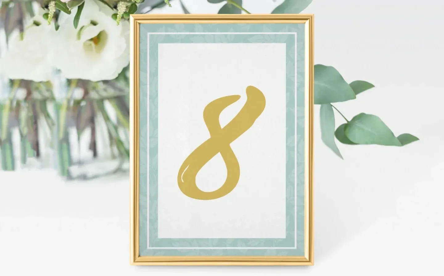 Elegant gold foil table number sign displayed as a wedding name card on a beautifully set table